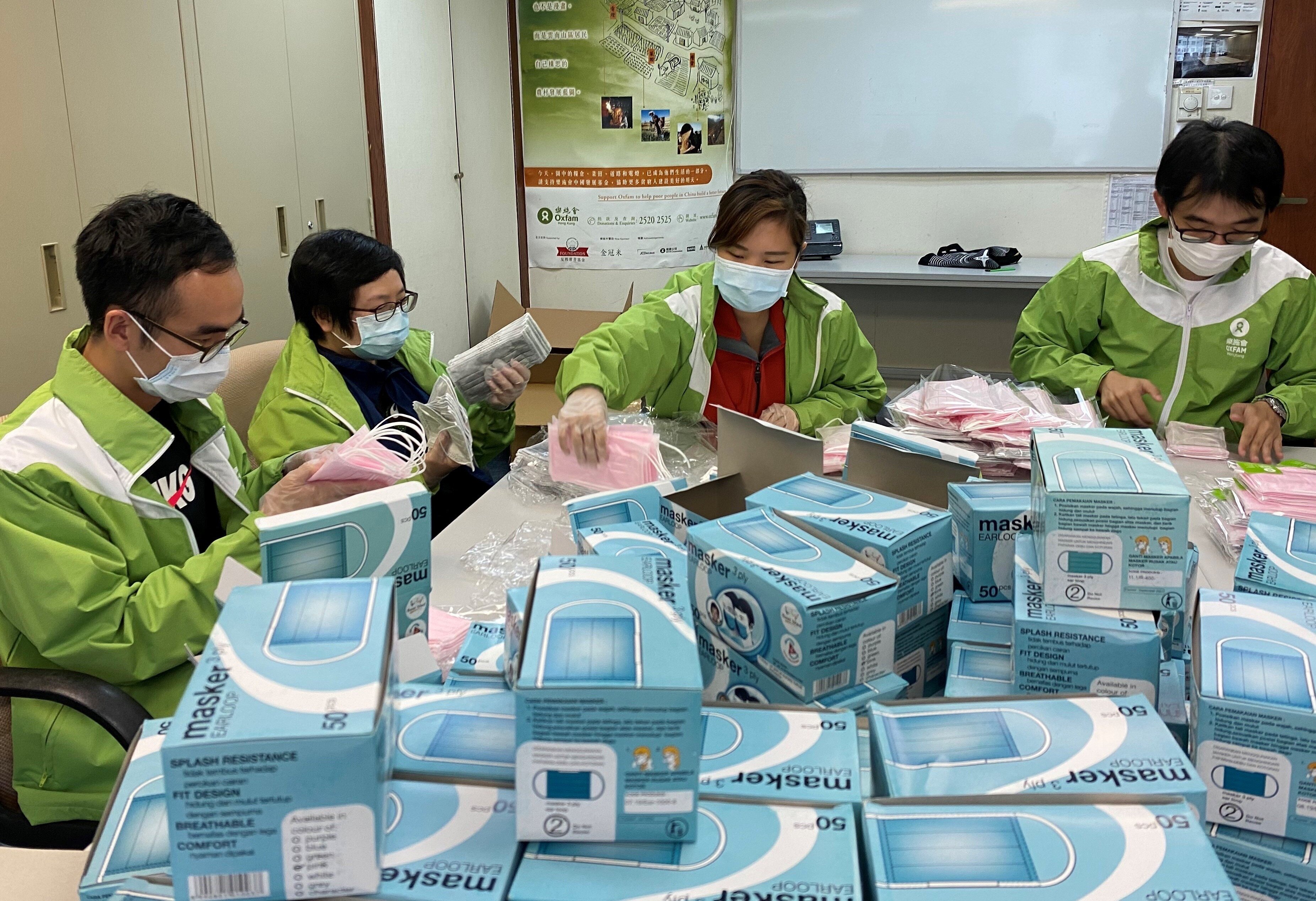 Oxfam staff packing masks